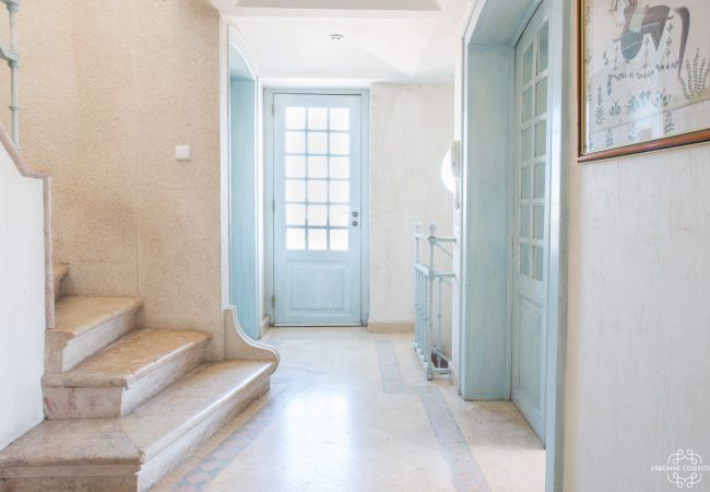 Bright entrance hall with stone staircase