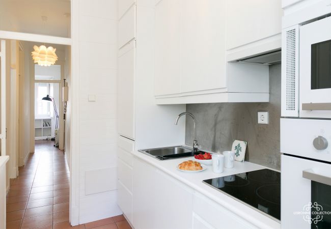 luxurious kitchen overlooking the entrance hallway with oven, microwave, hob