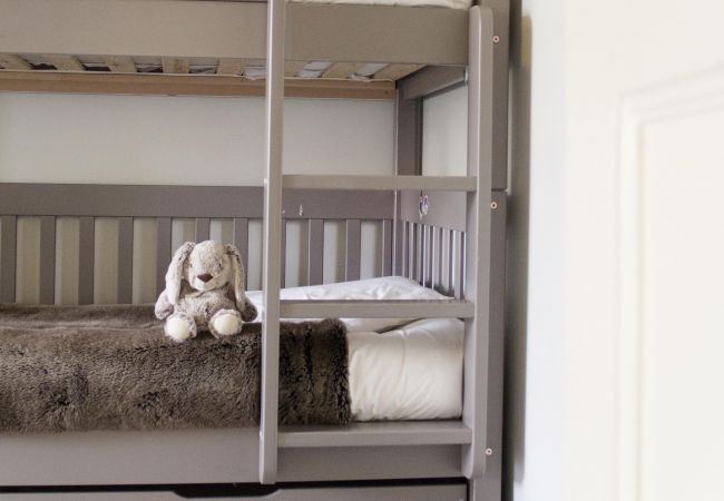 Child's play area with bunk beds in soft tones