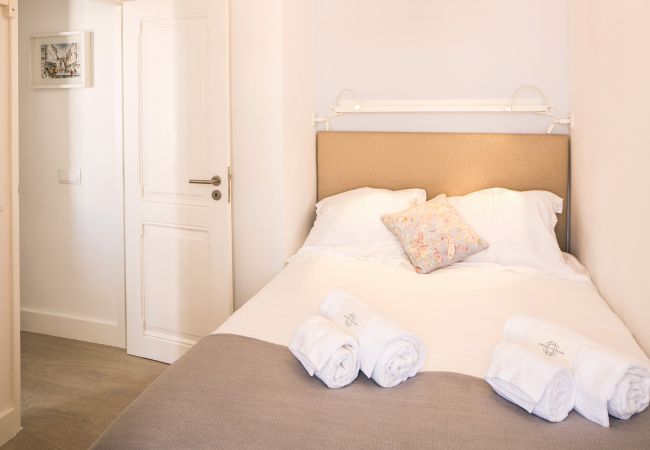 Double bed with folded towels on the bed in the historic center of Lisbon 