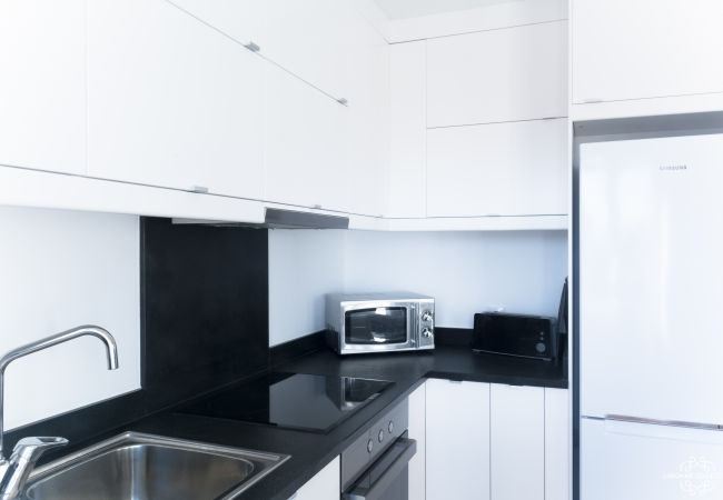Large modern black and white kitchen with microwave 