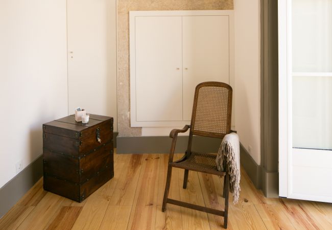 Decoration with rustic chair and wooden bedside table in front of a window