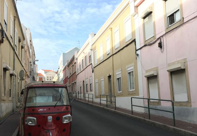 Typical Lisbon street with tuk-tuk to visit the city quickly
