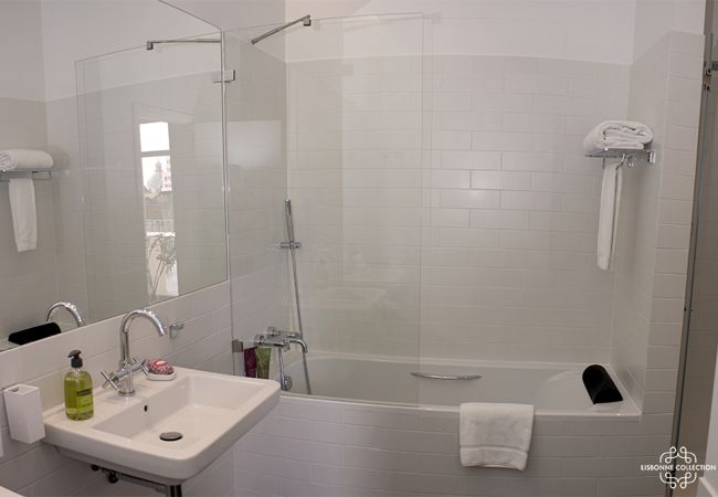 White bathroom with standing bathtub