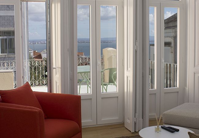 French window leading to a large terrace with a beautiful view of the Tagus