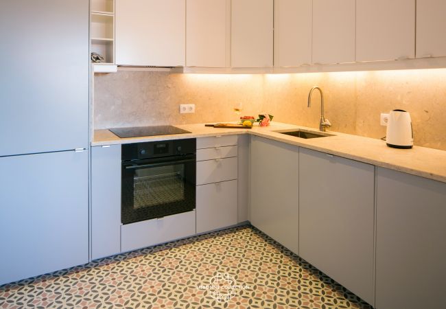 tiled kitchen with oven and hob